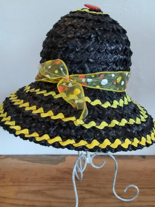 A black straw hat with yellow ribbon.