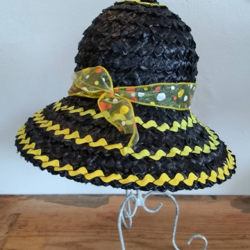 A black straw hat with yellow ribbon.